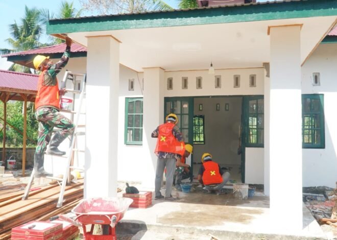 Gotong Royong Satgas dan Warga Percepat Pemasangan Keramik Musholla Darul Iman