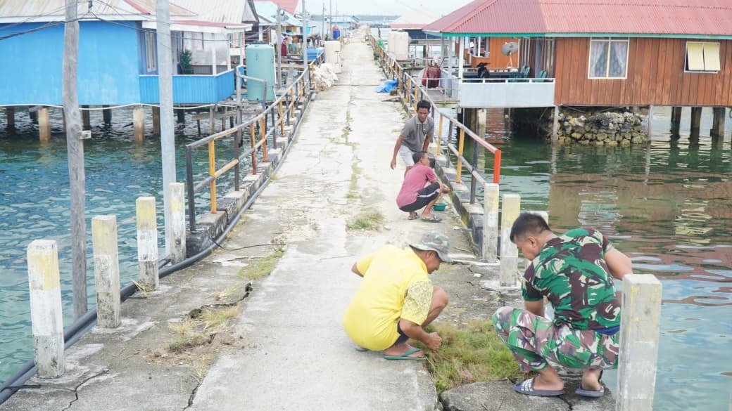 Satgas TMMD dan Warga Gotong Royong Cat Dermaga Desa Umbele