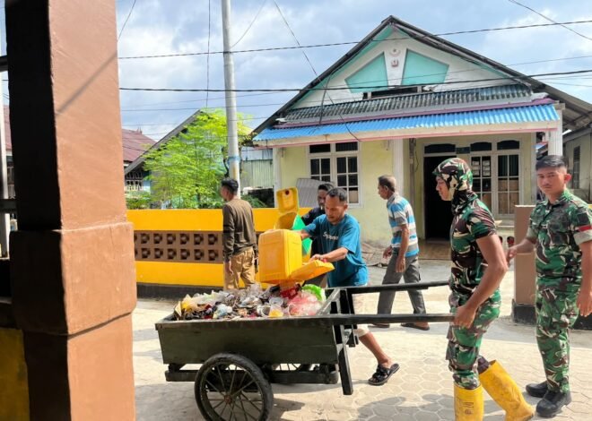 Satgas TMMD dan Warga Bersihkan Tempat Pembuangan Sampah di Desa Umbele
