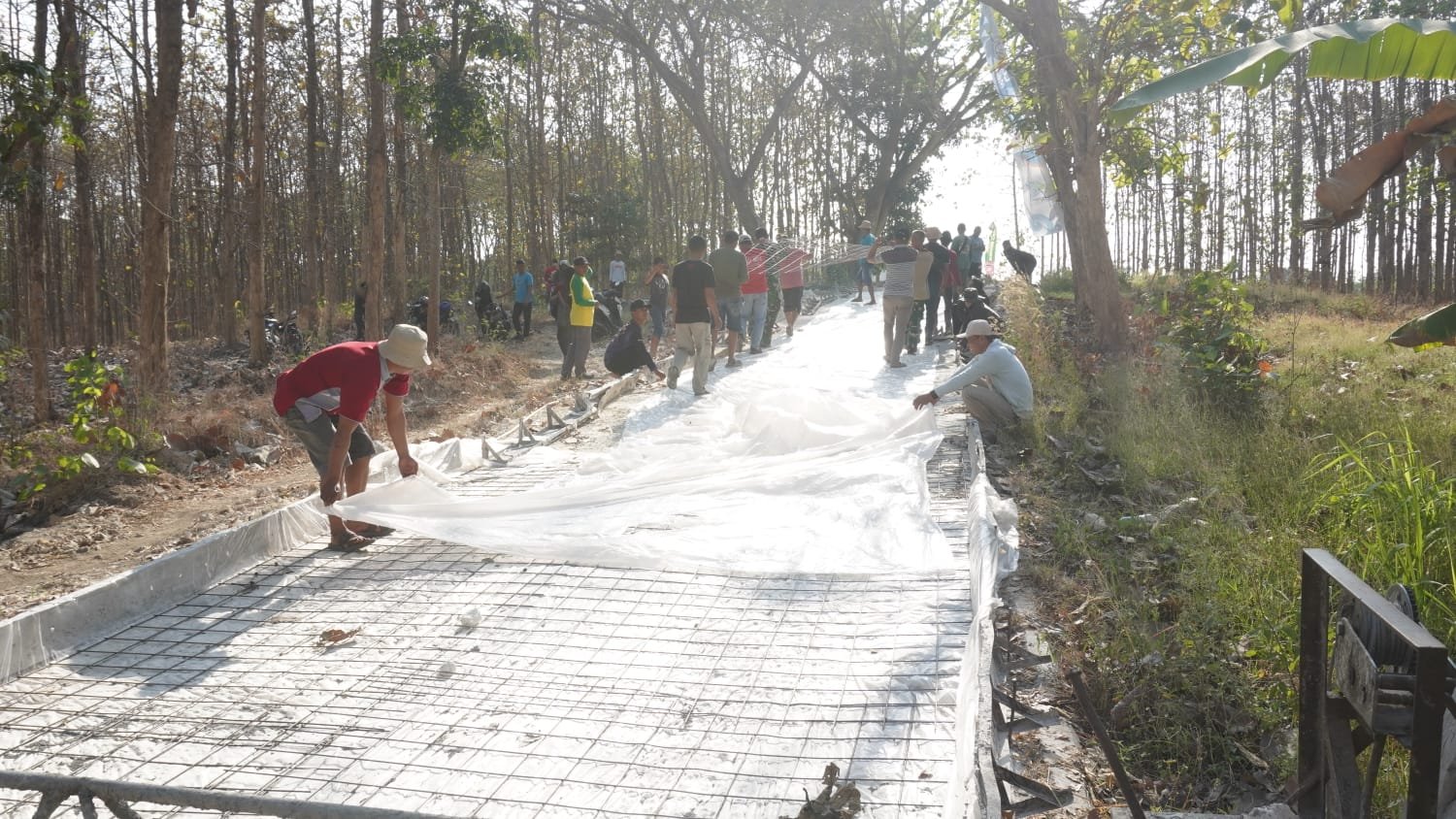 Wujud Kemanunggalan: Satgas TMMD ke-129 Kodim 0812/Lamongan Berjibaku Bersama Warga Gelar Plastik dan Wiremesh Demi Jalan Berkualitas di Desa Tlemang